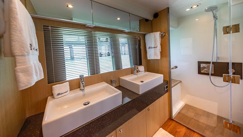 Blessed Yacht Photos Pics Luxurious bathroom in 2015 Fairline Squadron 65 yacht with dual sinks and modern shower.