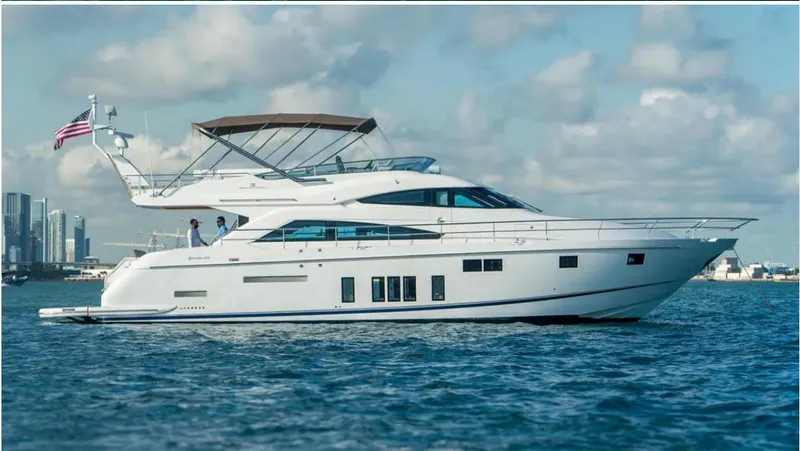 Blessed Yacht Photos Pics 2015 Fairline Squadron 65 yacht cruising on open water with city skyline backdrop.