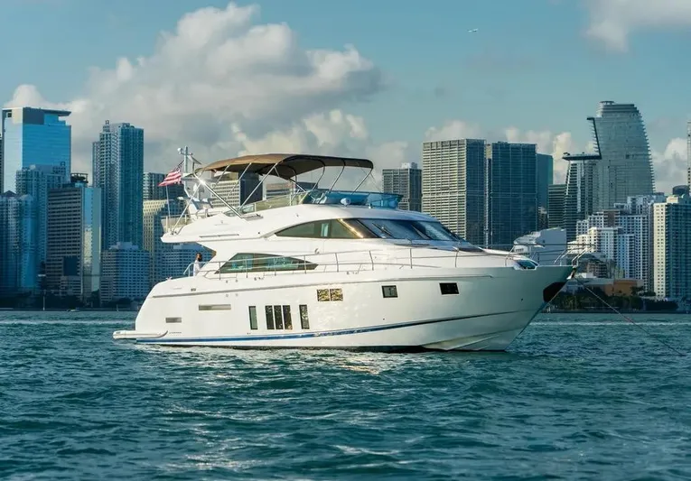Blessed Yacht Photos Pics Luxury 2015 Fairline Squadron 65 yacht cruising near city skyline.
