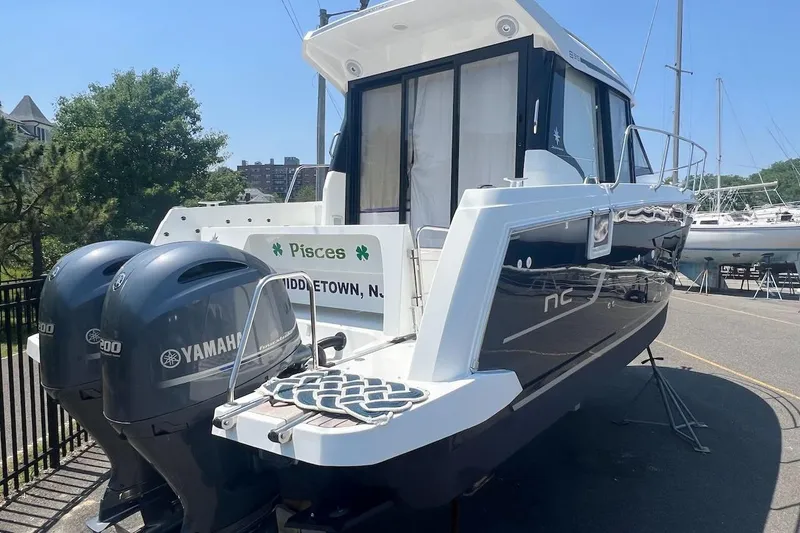 Pisces Yacht Photos Pics 2021 Jeanneau NC 895 boat with twin Yamaha engines, docked in Middletown.