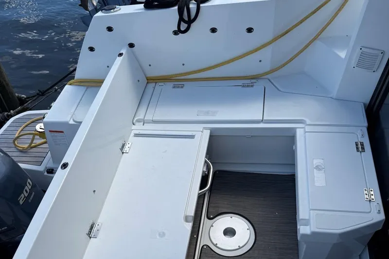 Pisces Yacht Photos Pics 2021 Jeanneau NC 895 boat deck with storage compartments and Yamaha 200 engine.