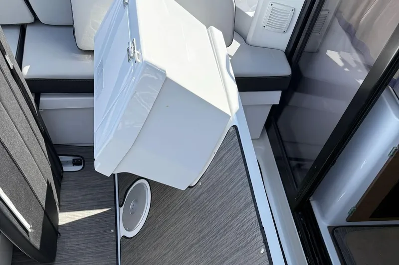 Pisces Yacht Photos Pics 2021 Jeanneau NC 895 interior with seating and storage compartment.