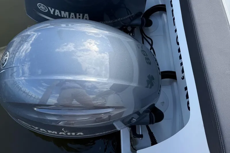 Pisces Yacht Photos Pics Yamaha outboard engine on 2021 Jeanneau NC 895 boat, reflecting sky and clouds.