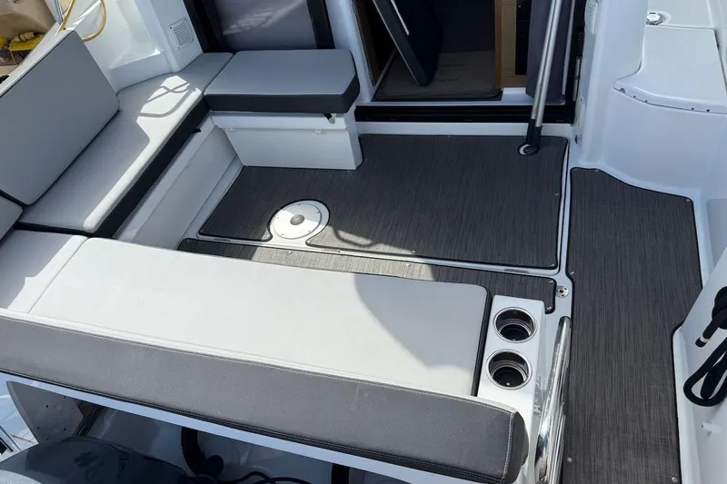 Pisces Yacht Photos Pics 2021 Jeanneau NC 895 boat interior with cushioned seating and modern flooring.