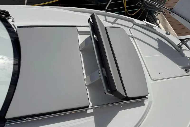 Pisces Yacht Photos Pics 2021 Jeanneau NC 895 boat deck with cushioned seating and sleek design.