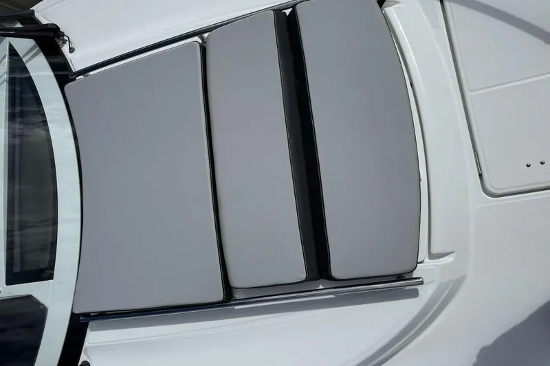 Pisces Yacht Photos Pics 2021 Jeanneau NC 895 boat deck with cushioned seating area.