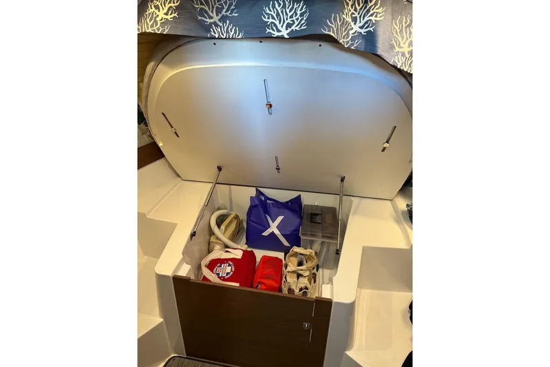 Pisces Yacht Photos Pics 2021 Jeanneau NC 895 storage compartment with bags and accessories.