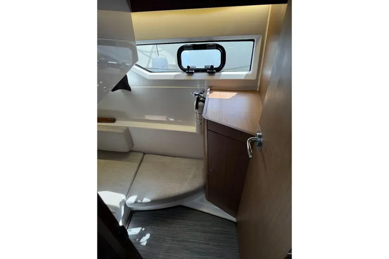 Pisces Yacht Photos Pics Interior cabin of 2021 Jeanneau NC 895 boat, featuring seating and a window.
