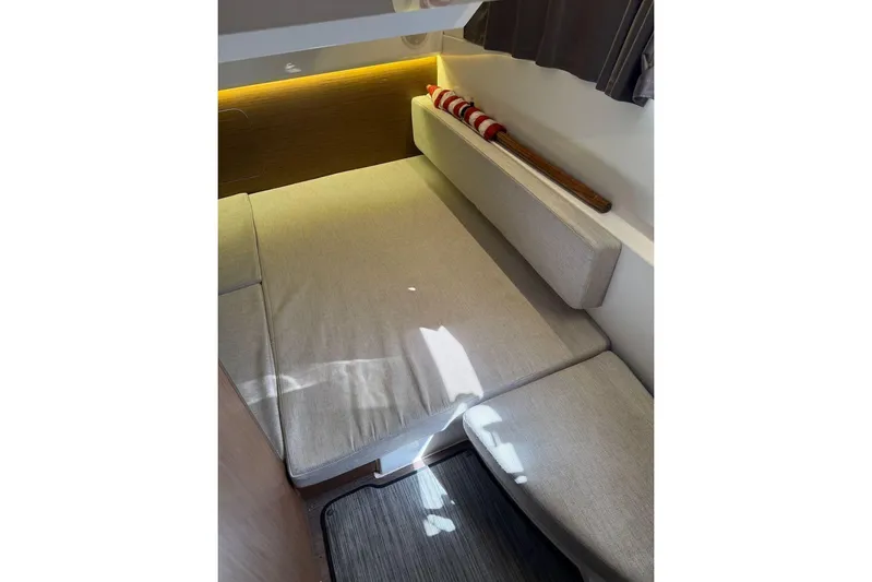 Pisces Yacht Photos Pics Interior cabin of 2021 Jeanneau NC 895 boat with cushioned seating and ambient lighting.