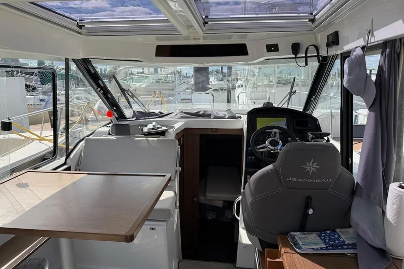 Pisces Yacht Photos Pics Interior of 2021 Jeanneau NC 895 boat with helm, seating, and table.