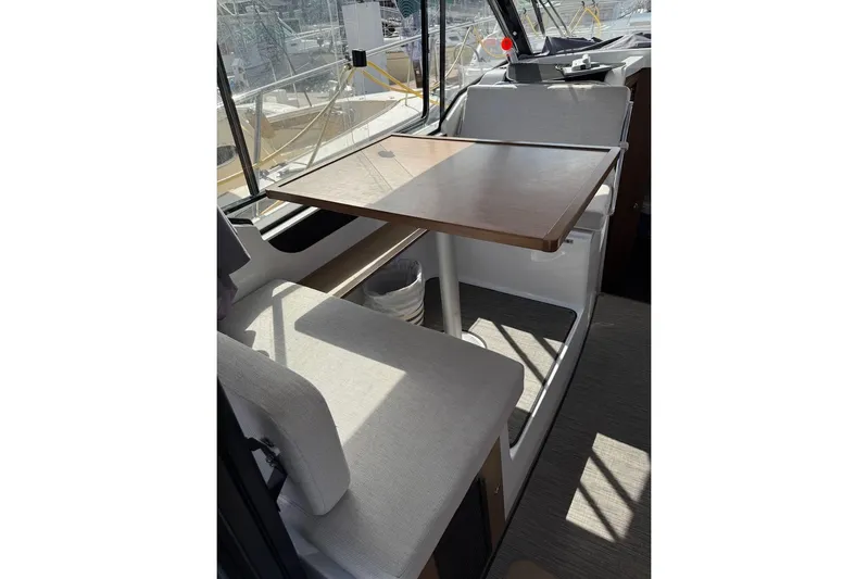 Pisces Yacht Photos Pics Interior of 2021 Jeanneau NC 895 boat with seating and table.