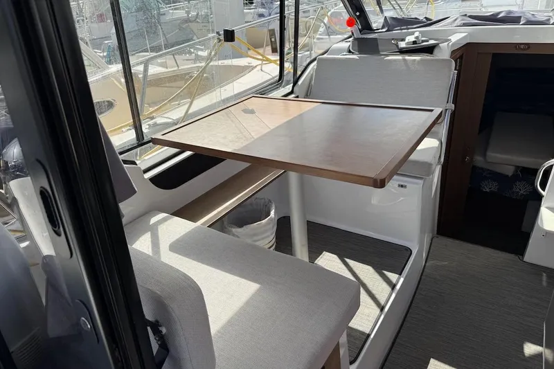 Pisces Yacht Photos Pics Interior of 2021 Jeanneau NC 895 boat with dining area and seating.