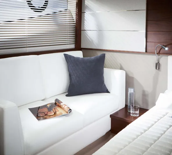  Yacht Photos Pics Luxurious interior of 2025 Princess V50 Open yacht with white sofa and decor.