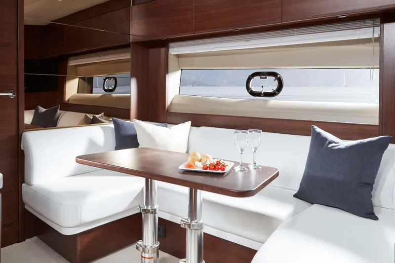  Yacht Photos Pics Luxurious interior of 2025 Princess V50 Open yacht with elegant seating and dining area.