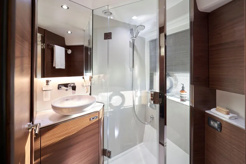  Yacht Photos Pics Luxurious bathroom in 2025 Princess V50 Open yacht with modern fixtures and glass shower.