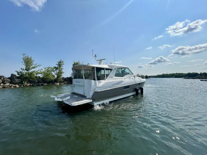  Yacht Photos Pics 2011 Cruisers Yachts 48 Cantius on serene water under a clear blue sky.