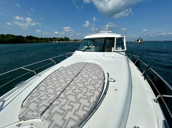  Yacht Photos Pics 2011 Cruisers Yachts 48 Cantius on water, sunny day, front deck view.