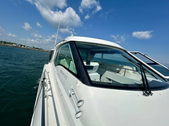  Yacht Photos Pics 2011 Cruisers Yachts 48 Cantius on water under blue sky.