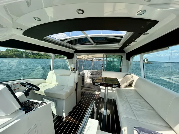  Yacht Photos Pics Luxurious 2011 Cruisers Yachts 48 Cantius interior with spacious seating and panoramic windows.