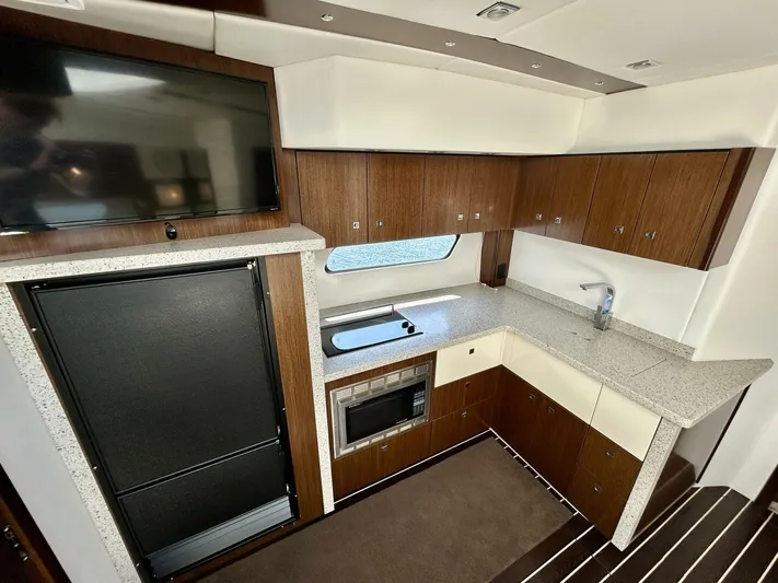  Yacht Photos Pics Luxurious 2011 Cruisers Yachts 48 Cantius kitchen with modern appliances and sleek cabinetry.