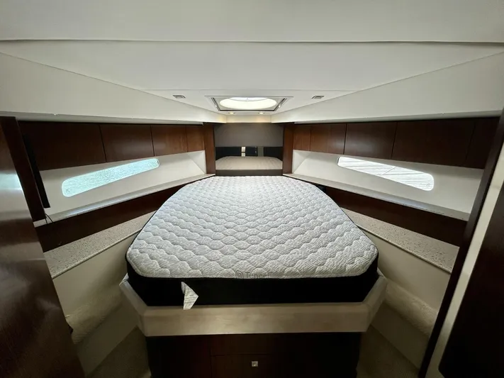  Yacht Photos Pics Luxurious bedroom interior of 2011 Cruisers Yachts 48 Cantius with elegant wood finishes.