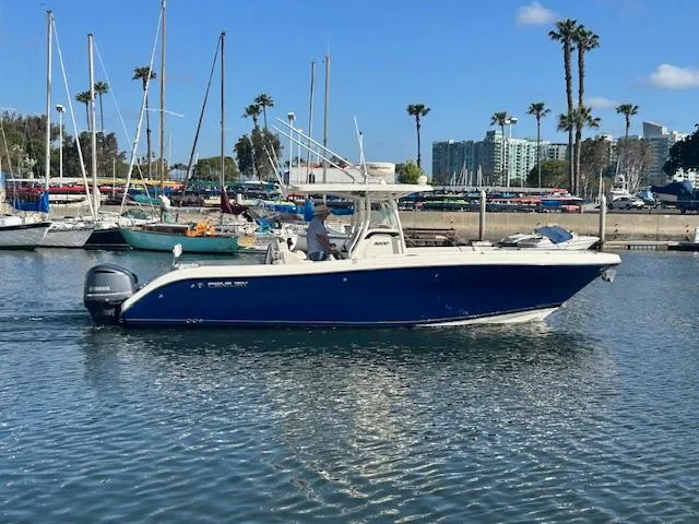 Dolce Vita Yacht Photos Pics 2016 Century 3200 Center Console boat in marina, surrounded by sailboats and palm trees.