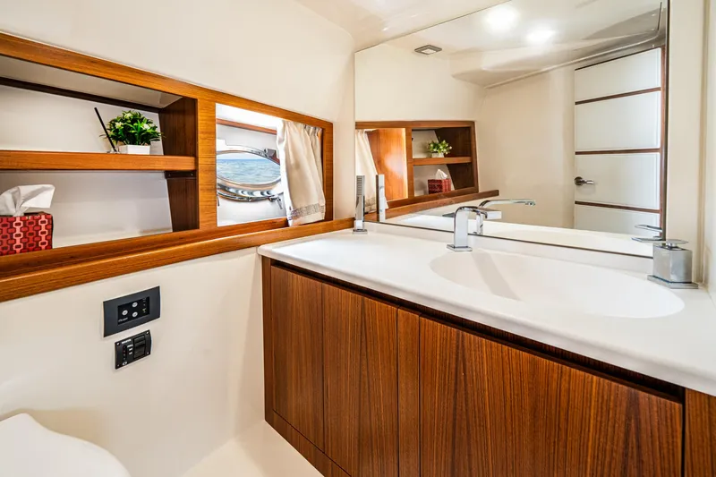Penrose Yacht Photos Pics Luxurious bathroom in 2020 Gagliotta Lobster 35 yacht with wooden cabinetry and modern fixtures.