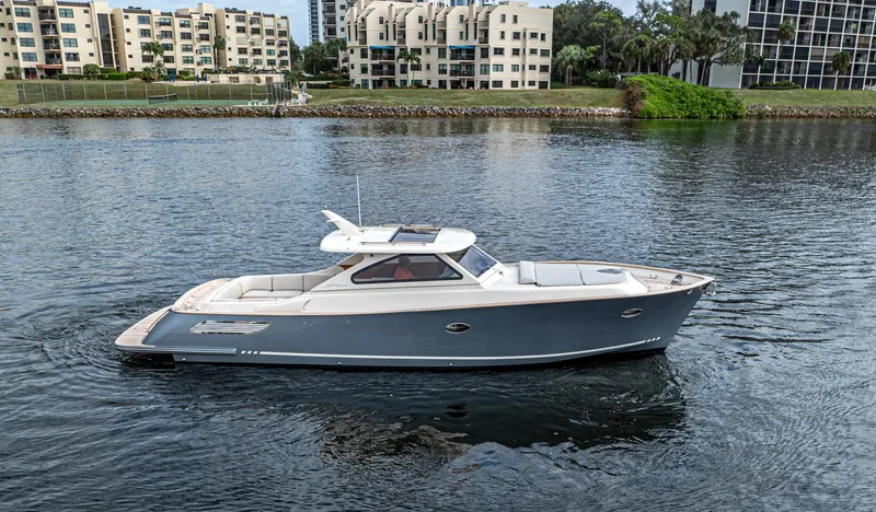 Penrose Yacht Photos Pics 2020 Gagliotta Lobster 35 boat on calm water near modern buildings.