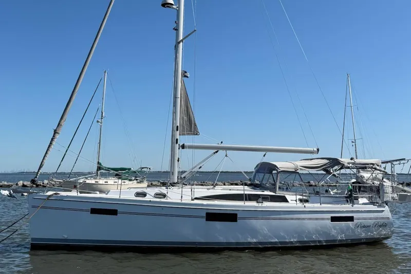 Picture Perfect Yacht Photos Pics 2022 Catalina 425 sailboat docked on calm water under clear blue sky.