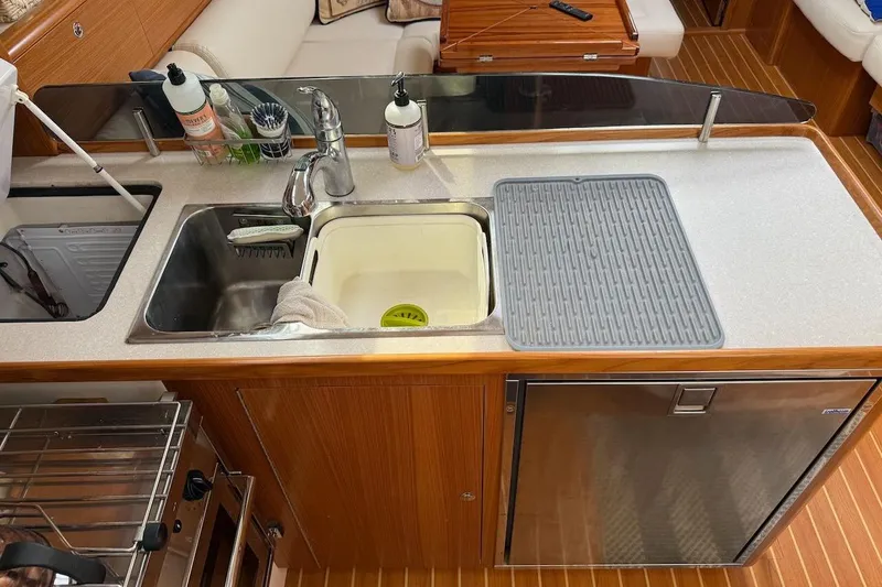 Picture Perfect Yacht Photos Pics Modern kitchen area in a 2022 Catalina 425 yacht, featuring a sink and countertop.