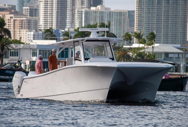  Yacht Photos Pics 2025 Front Runner 43 Catamaran cruising in urban waterfront setting.