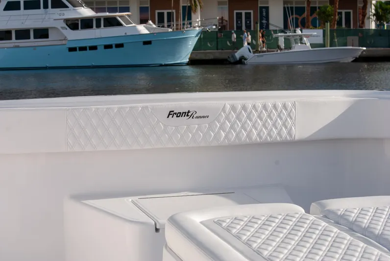  Yacht Photos Pics Front Runner 43 Catamaran 2025, white interior with quilted seating, docked near waterfront.