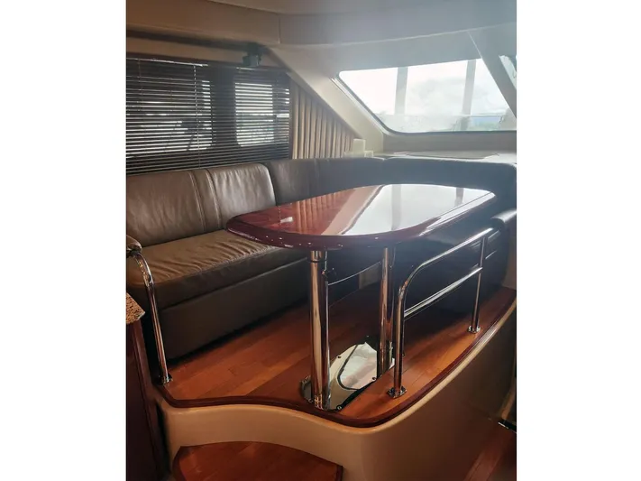  Yacht Photos Pics Luxurious interior of 2007 Sea Ray 52 Sedan Bridge yacht with leather seating and polished table.