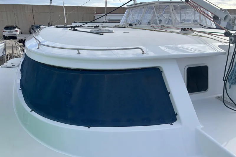  Yacht Photos Pics 2009 Kelsall 58 KSS yacht with sleek design and tinted windows at a marina.