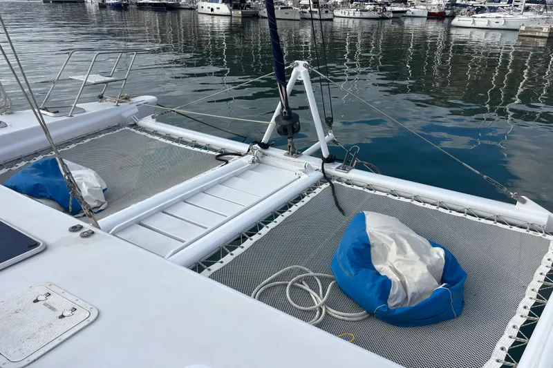  Yacht Photos Pics 2009 Kelsall 58 KSS catamaran with netted deck, docked in a marina.