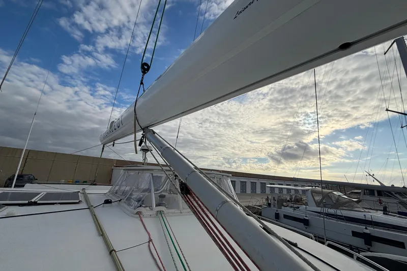  Yacht Photos Pics Sailboat deck view of 2009 Kelsall 58 KSS under a partly cloudy sky.