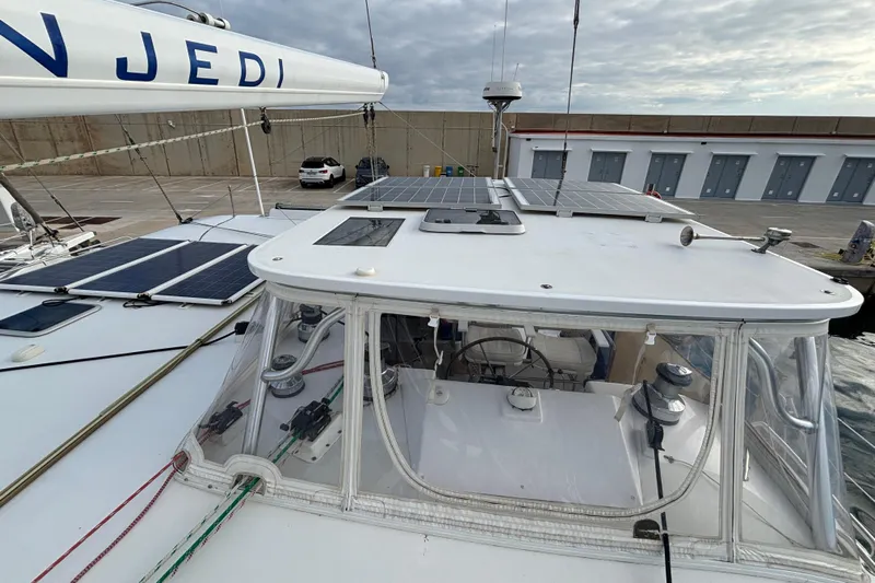  Yacht Photos Pics Kelsall 58 KSS 2009 catamaran with solar panels docked at a marina.