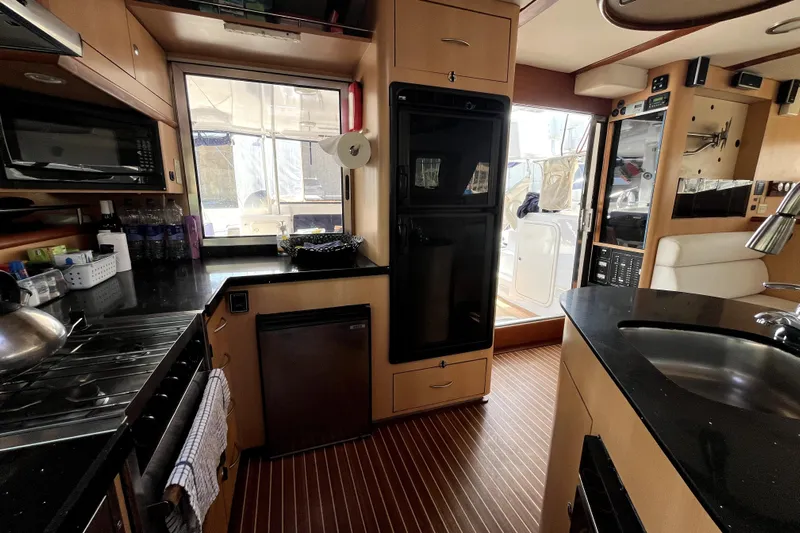  Yacht Photos Pics Interior of 2009 Kelsall 58 KSS yacht, featuring modern kitchen and sleek design.