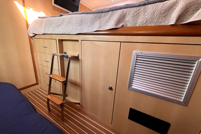  Yacht Photos Pics Interior of 2009 Kelsall 58 KSS yacht with wooden cabinetry and ladder.