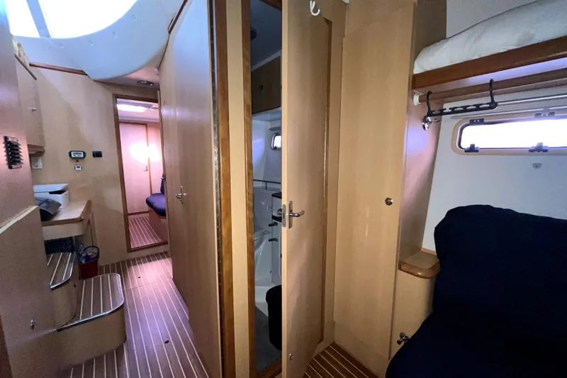  Yacht Photos Pics Interior of 2009 Kelsall 58 KSS yacht, featuring wood paneling and cozy seating.