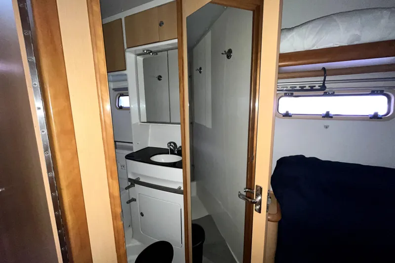  Yacht Photos Pics Interior of 2009 Kelsall 58 KSS yacht showing bathroom and bunk bed area.