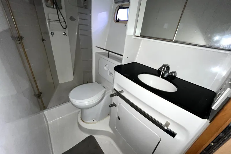  Yacht Photos Pics Bathroom interior of 2009 Kelsall 58 KSS yacht with shower, toilet, and sink.
