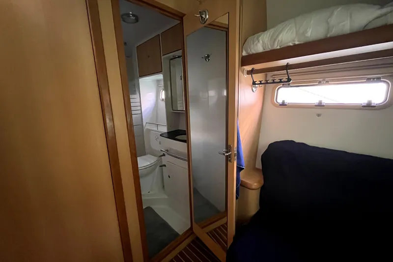  Yacht Photos Pics Interior of 2009 Kelsall 58 KSS yacht showing bathroom and cozy cabin space.