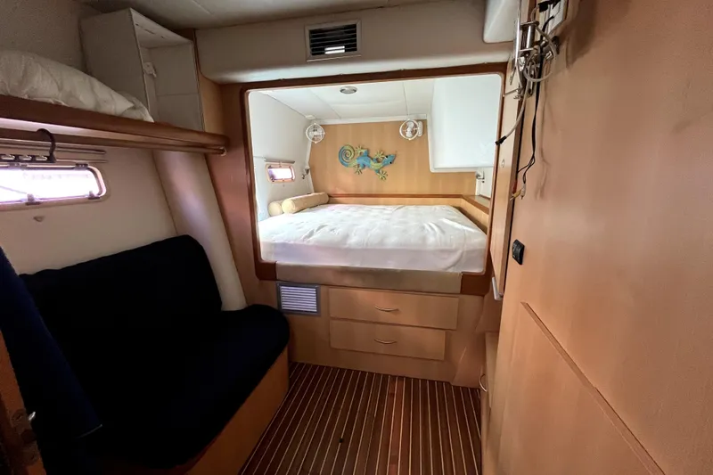  Yacht Photos Pics Cozy cabin interior of 2009 Kelsall 58 KSS yacht with bed and seating area.