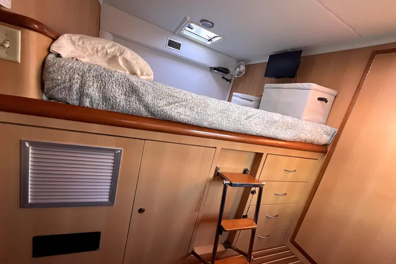  Yacht Photos Pics Cozy cabin interior of 2009 Kelsall 58 KSS with elevated bed and storage.