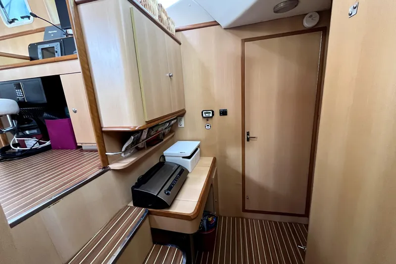  Yacht Photos Pics Interior of 2009 Kelsall 58 KSS yacht with wooden cabinetry and striped flooring.
