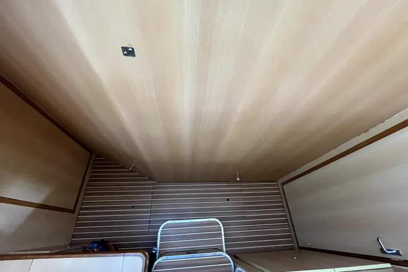  Yacht Photos Pics Interior of 2009 Kelsall 58 KSS yacht with wooden paneling and ladder.