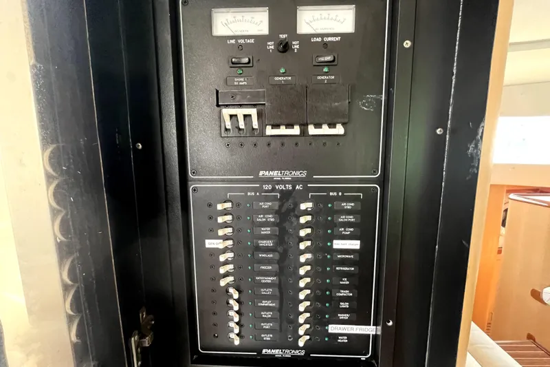  Yacht Photos Pics Electrical panel on a 2009 Kelsall 58 KSS boat, featuring circuit breakers and voltage meters.
