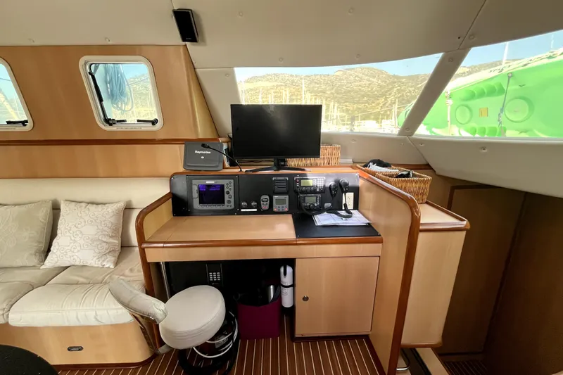  Yacht Photos Pics Interior of 2009 Kelsall 58 KSS yacht with navigation equipment and seating area.