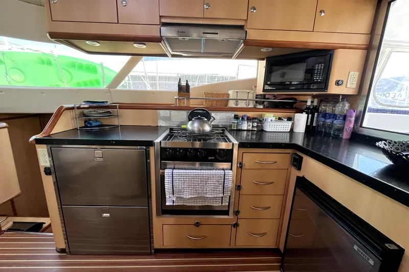  Yacht Photos Pics Modern kitchen in 2009 Kelsall 58 KSS yacht with appliances and wooden cabinetry.
